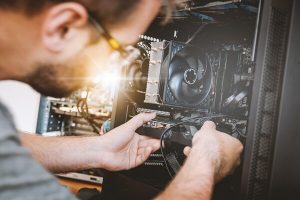 Computer technician working on a computer tower