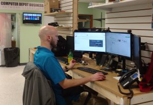 CD Technology Technician working at a desk