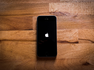 Apple Iphone laying on a wooden desk